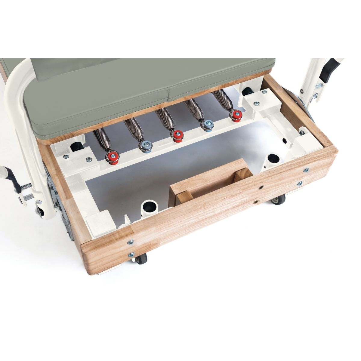 Pilates apparatus with wooden frame, gray padding, and visible springs.