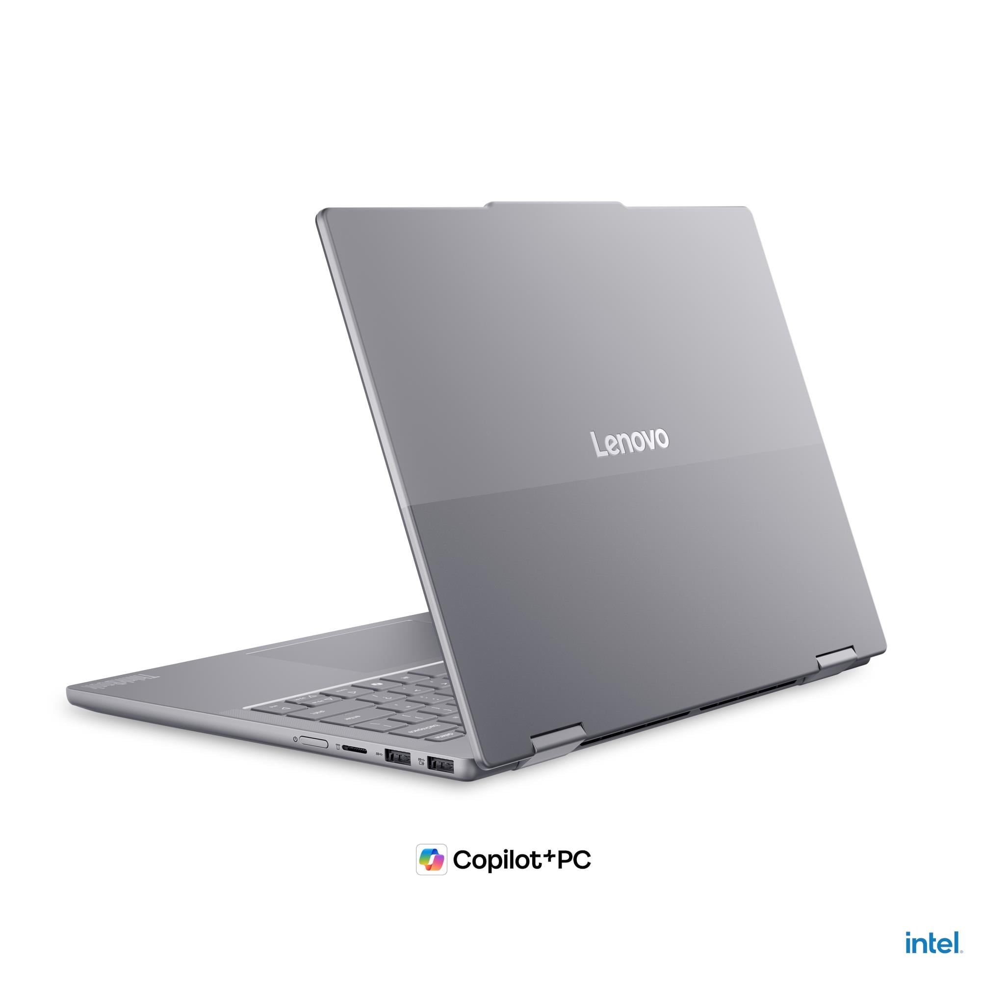 Laptop Lenovo grigio con tastiera e porte, loghi Copilot+PC e Intel.