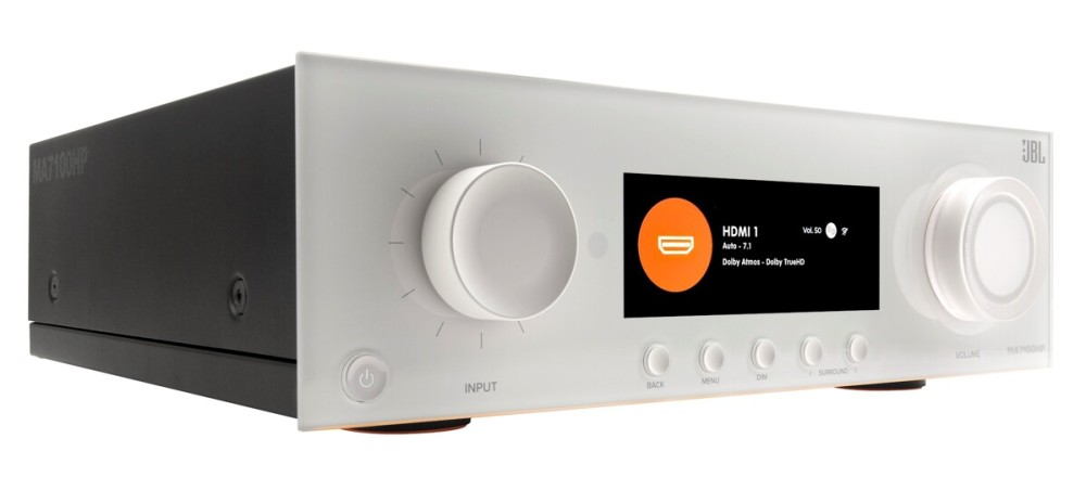 Srebrny odbiornik audio z czarną obudową, dużą gałką, ekranem i przyciskami.