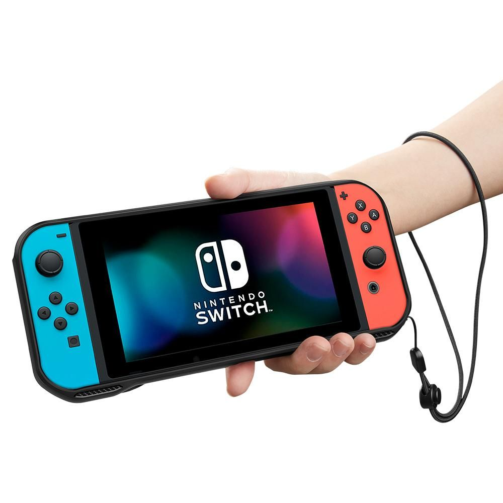 Una mano tiene una Nintendo Switch con schermo colorato e controller blu/rossi.