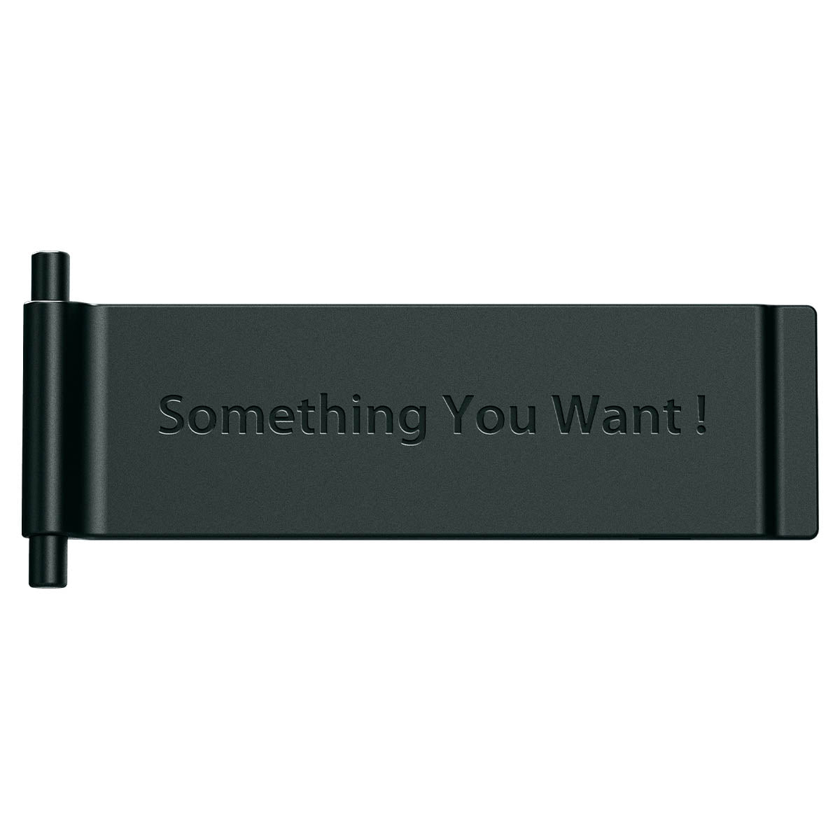 Oggetto nero con testo in rilievo "Something You Want!" su sfondo bianco.