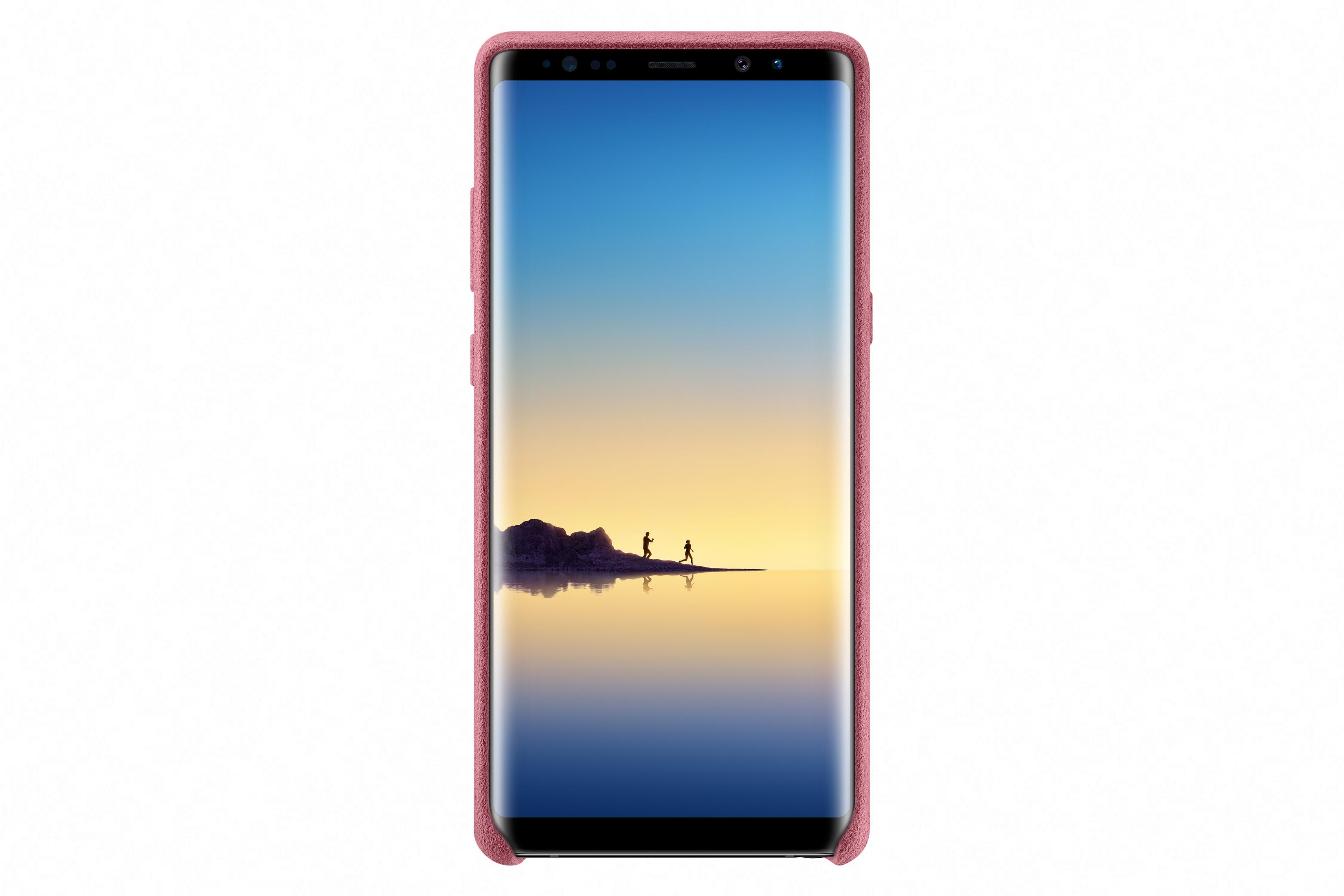 Uno smartphone rosa con uno sfondo di due corridori vicino all'acqua.