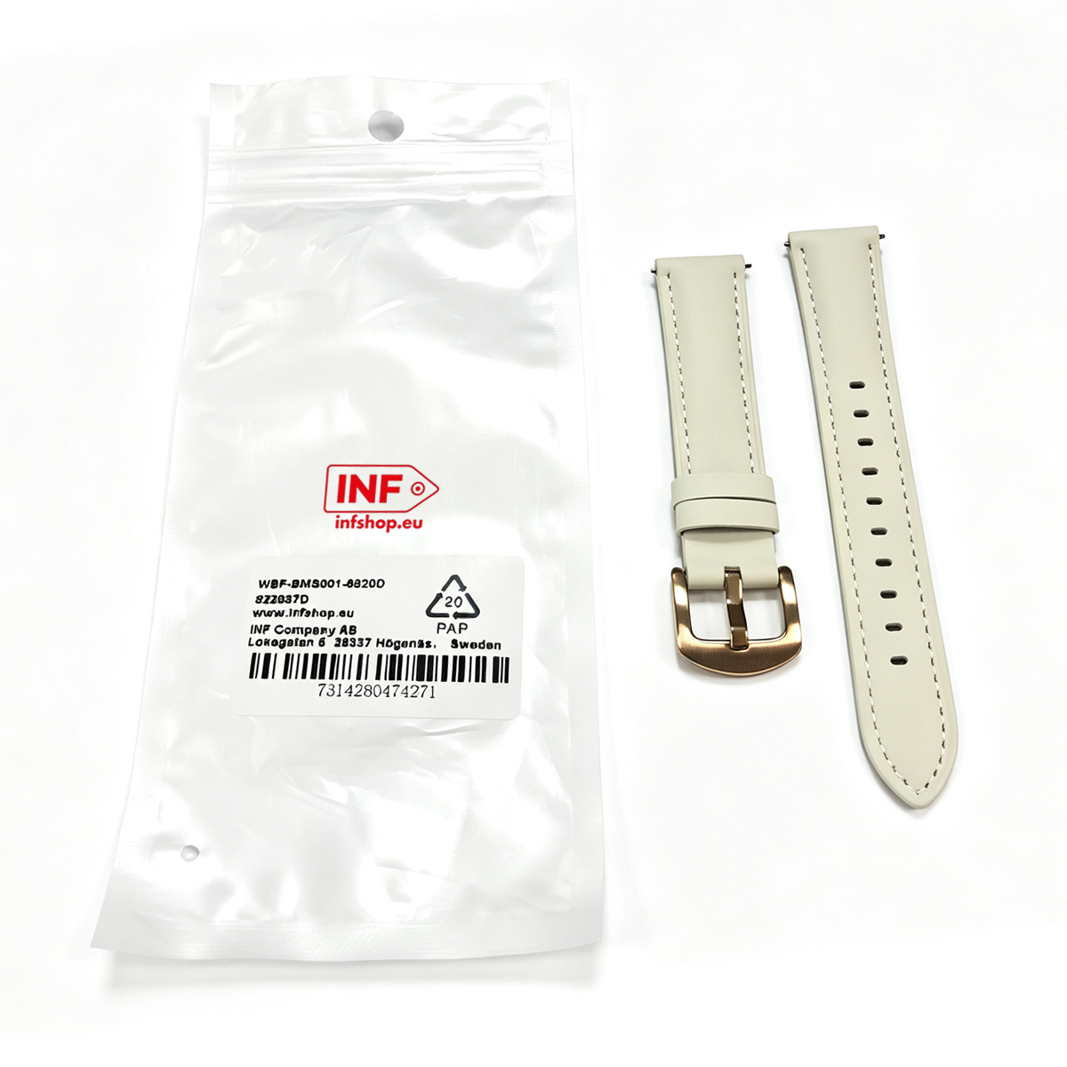 Un cinturino per orologio beige con fibbia accanto a una confezione.