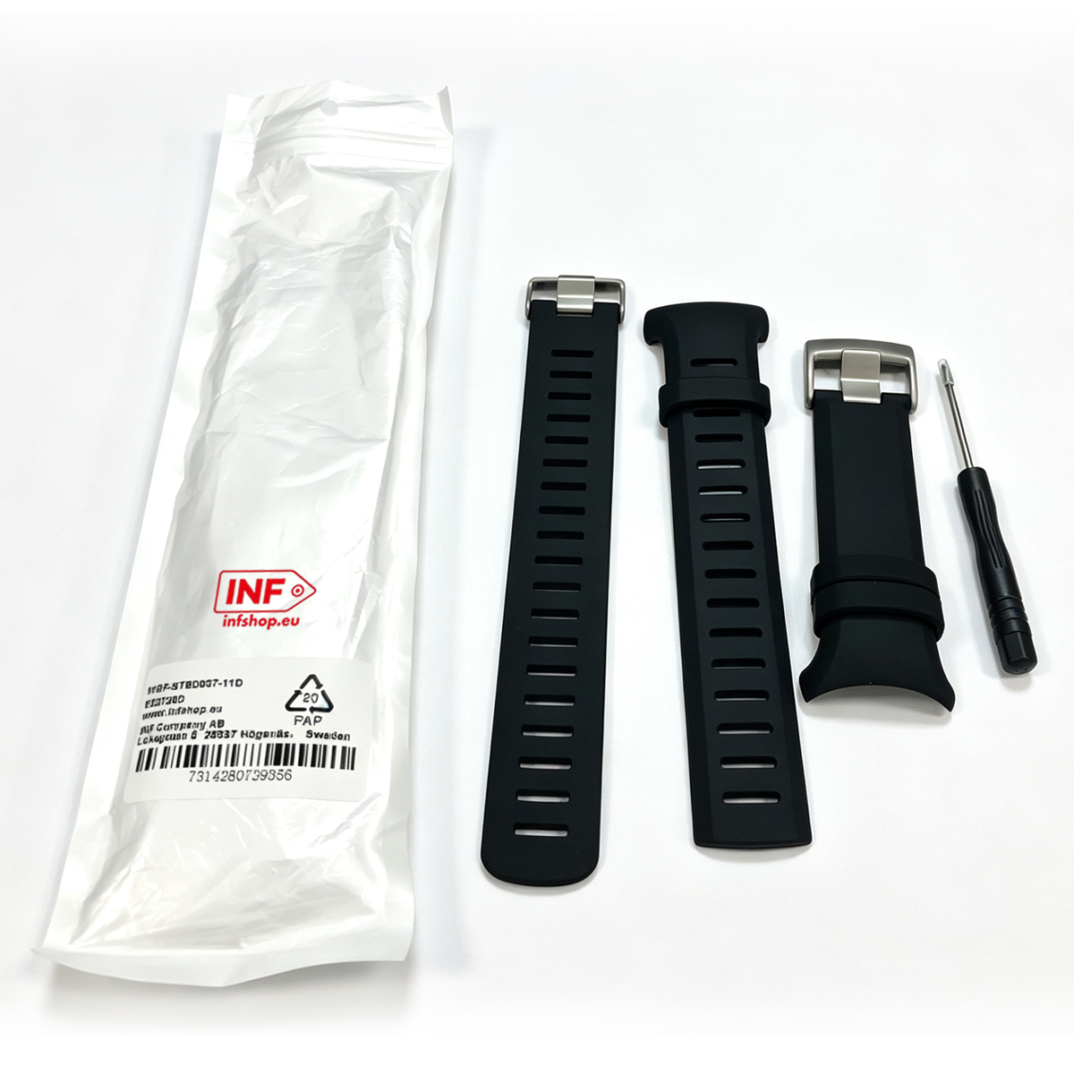 Schwarze Uhrenarmbänder und ein Werkzeug liegen neben einer weißen Verpackung.