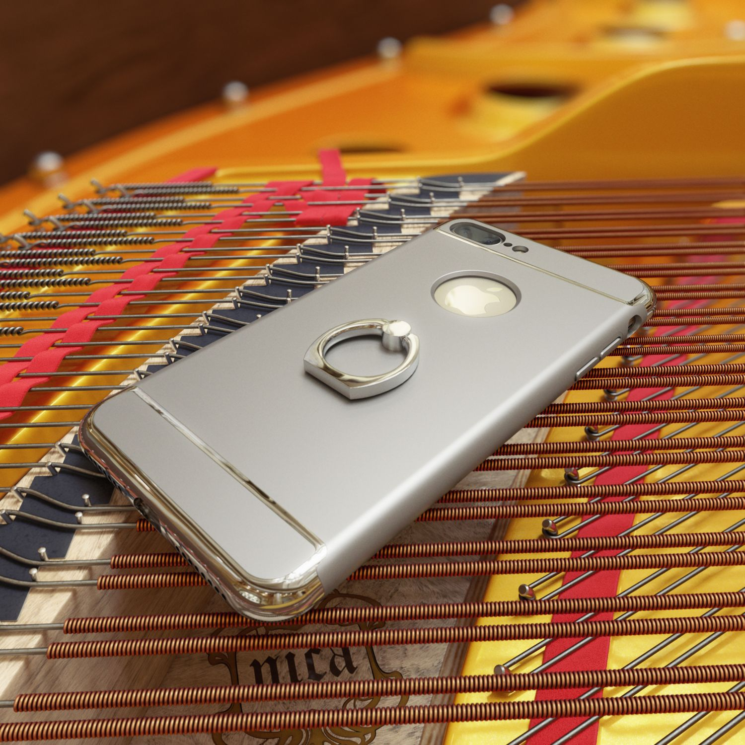 Silbernes Handy mit Ringhalter auf Klaviersaiten mit rotem Band.