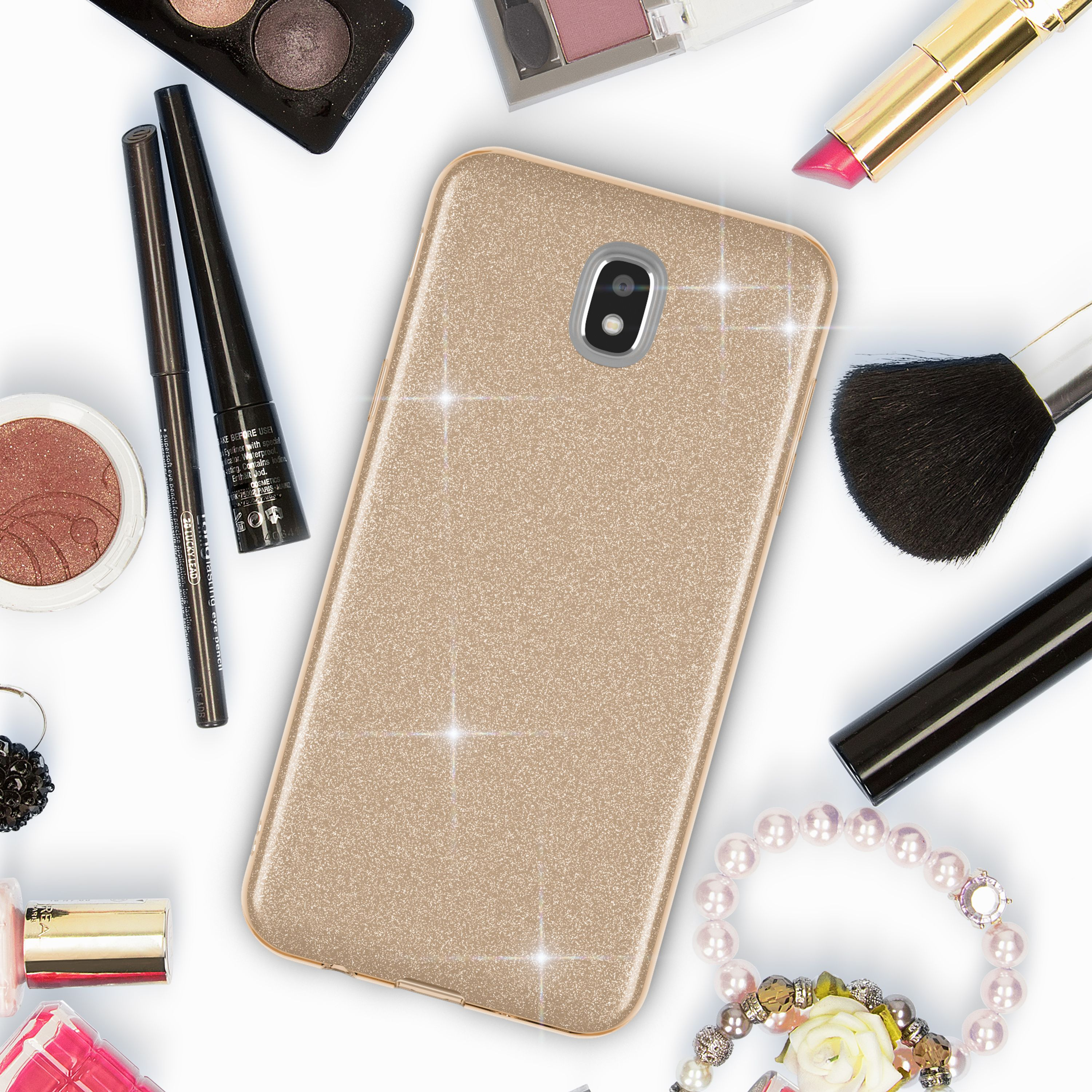 Goldenes Handyhülle umgeben von Kosmetik wie Lidschatten, Lippenstift und Pinsel.