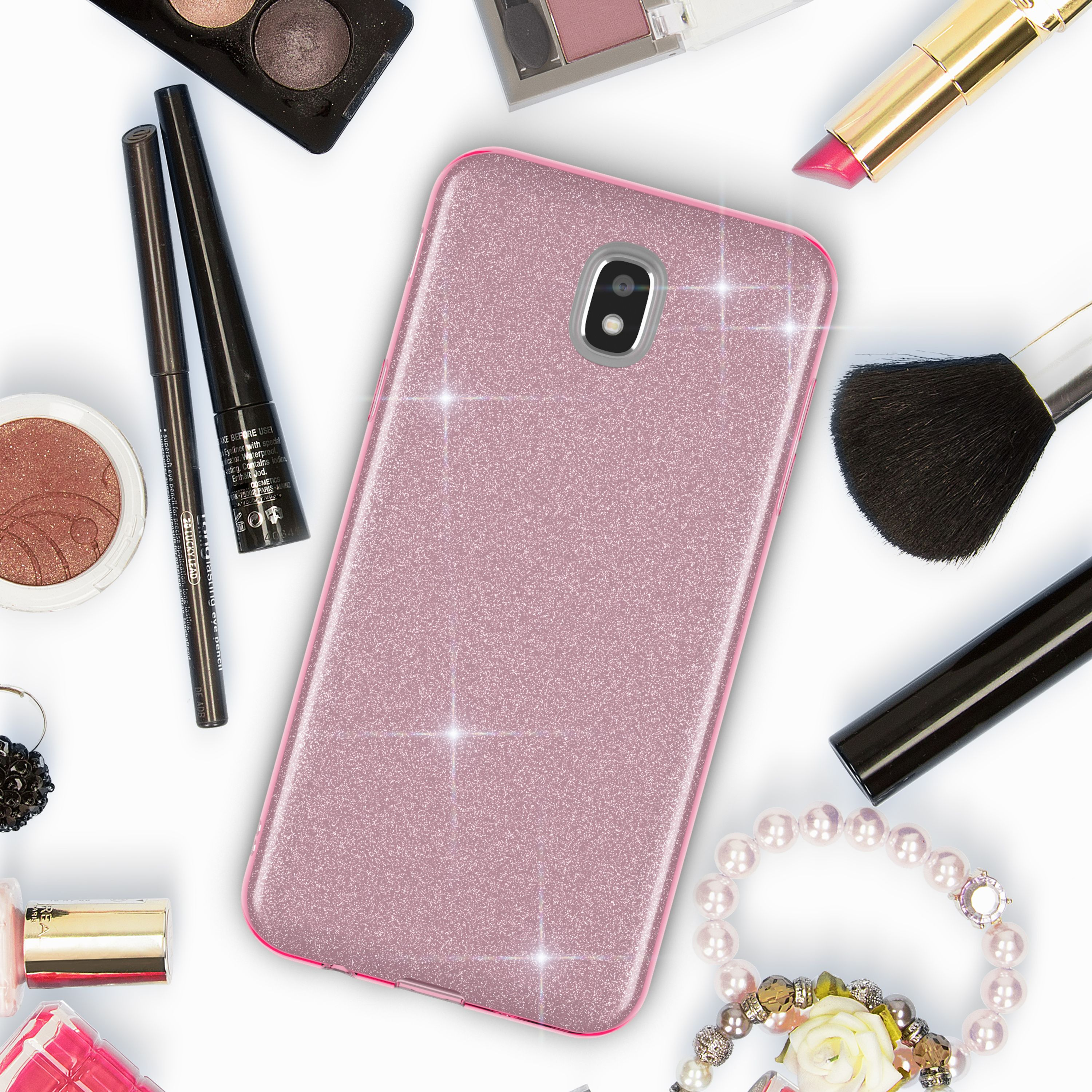 Ein rosafarbenes Handyhülle mit Glitzer umgeben von Make-up-Artikeln.