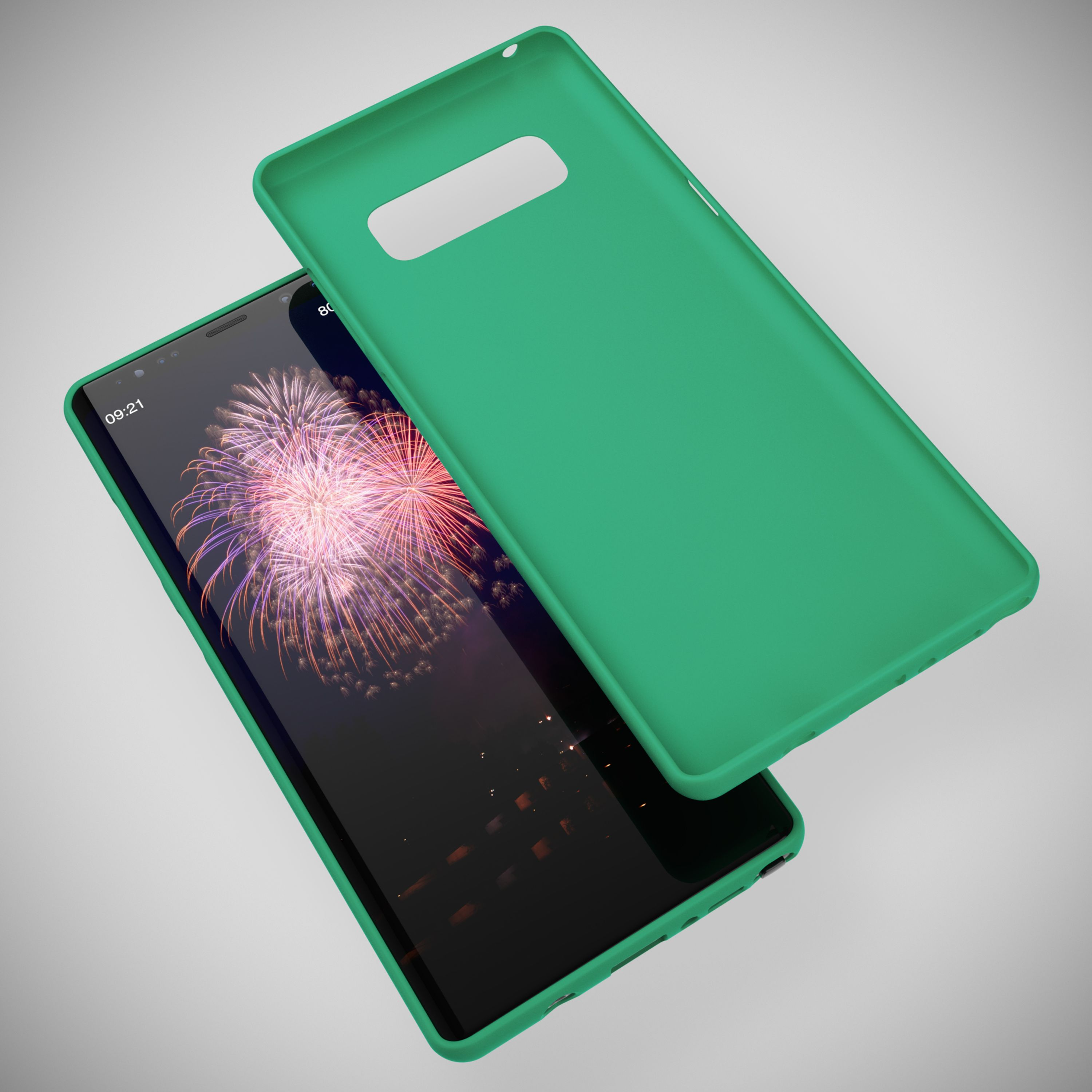 Ein grünes Handycover liegt neben einem Smartphone mit Feuerwerk-Hintergrund.
