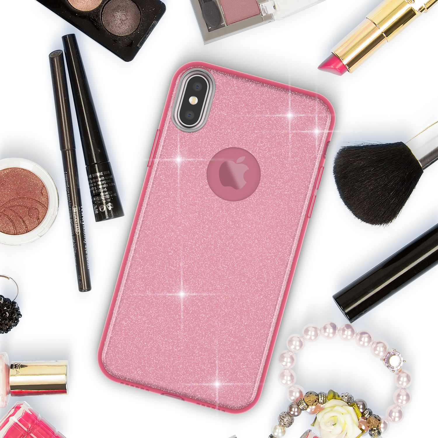 Glitzernde rosa Handyhülle umgeben von Kosmetika wie Lippenstift, Lidschatten, Bürsten.