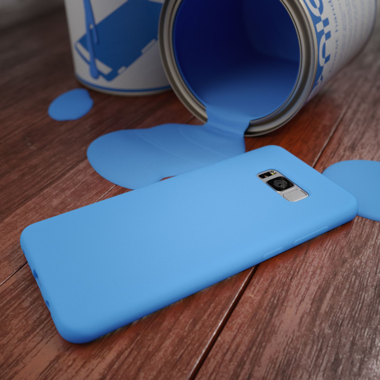Eine blaue Handyhülle liegt neben einer umgekippten Farb dose mit verschütteter blauer Farbe.