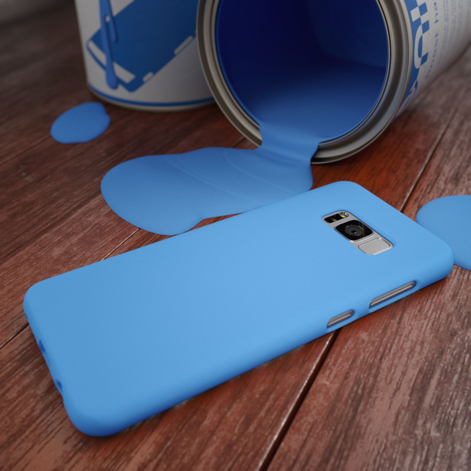 Ein blauer Handyhülle liegt neben einem umgekippten Farbeimer mit blauer Farbe.