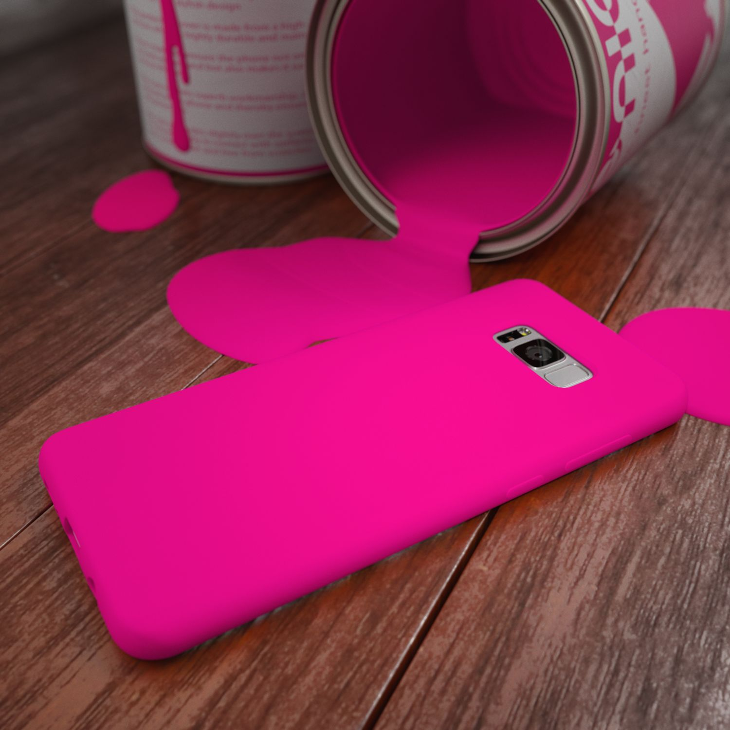 Ein pinker Farbeimer ist umgekippt und bedeckt einen Handyhülle auf Holzboden.
