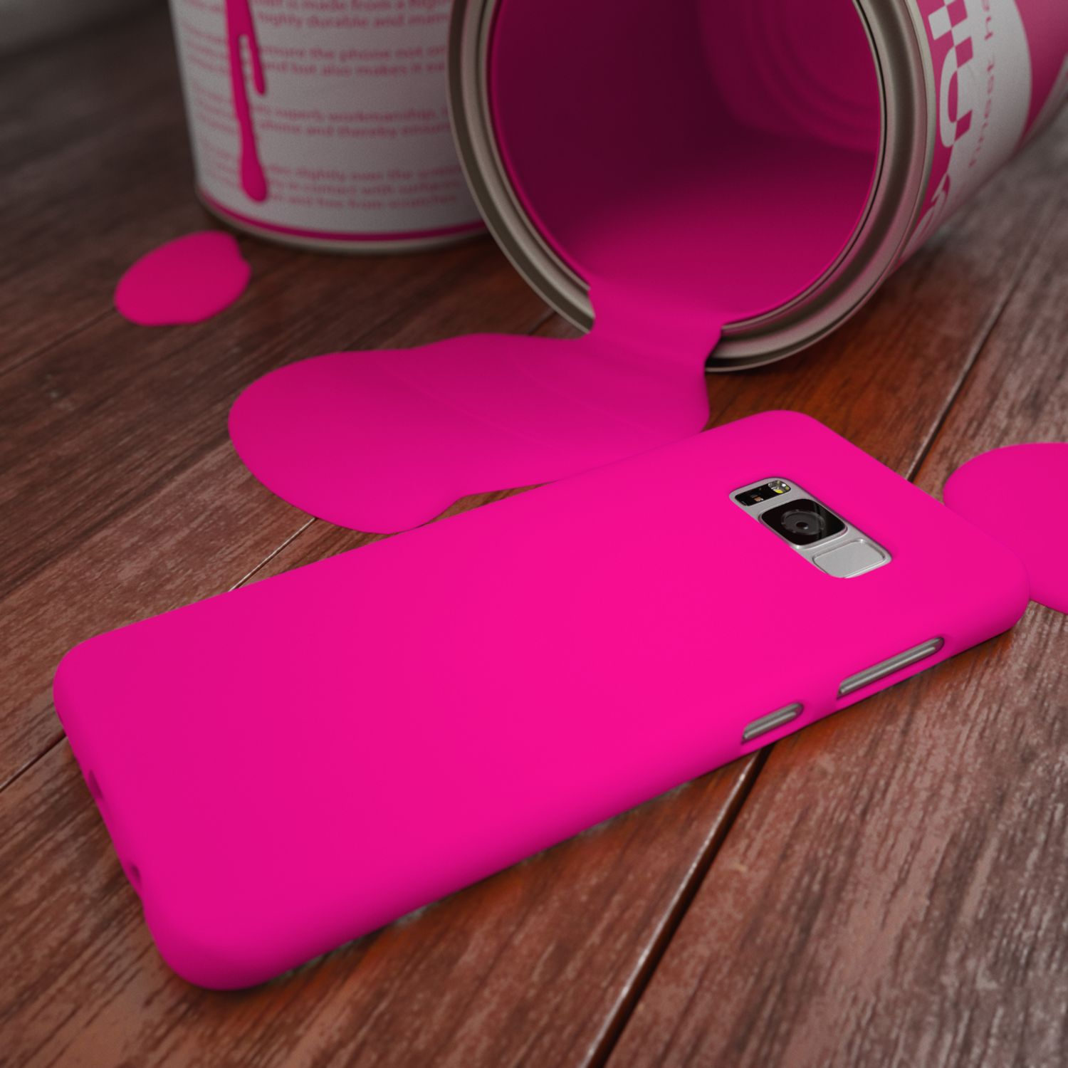 Ein pinker Handyhülle liegt neben einem umgekippten Farbeimer auf Holzdielen.