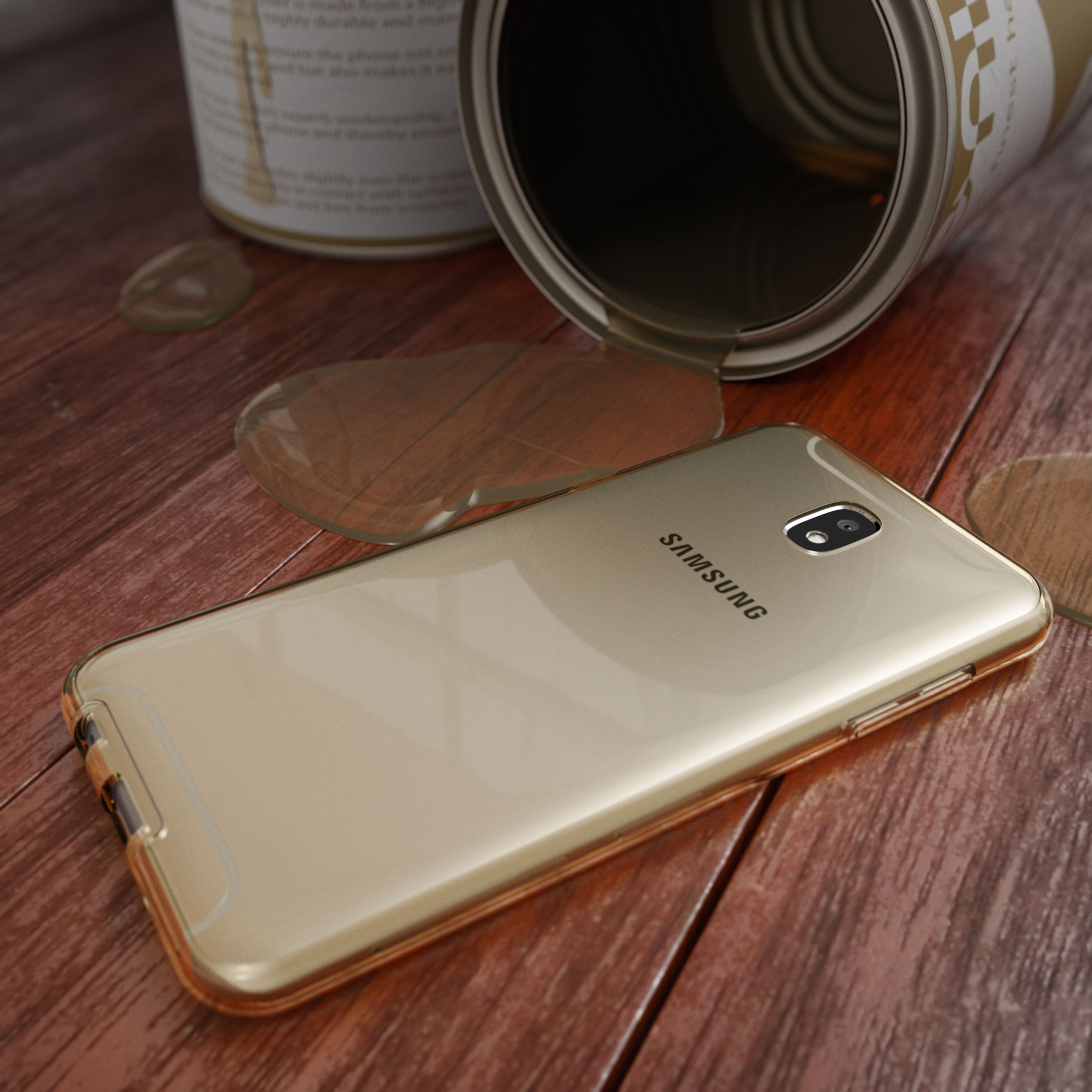 Ein goldener Samsung Handy liegt auf einem Holztisch neben einem umgekippten Farbeimer.