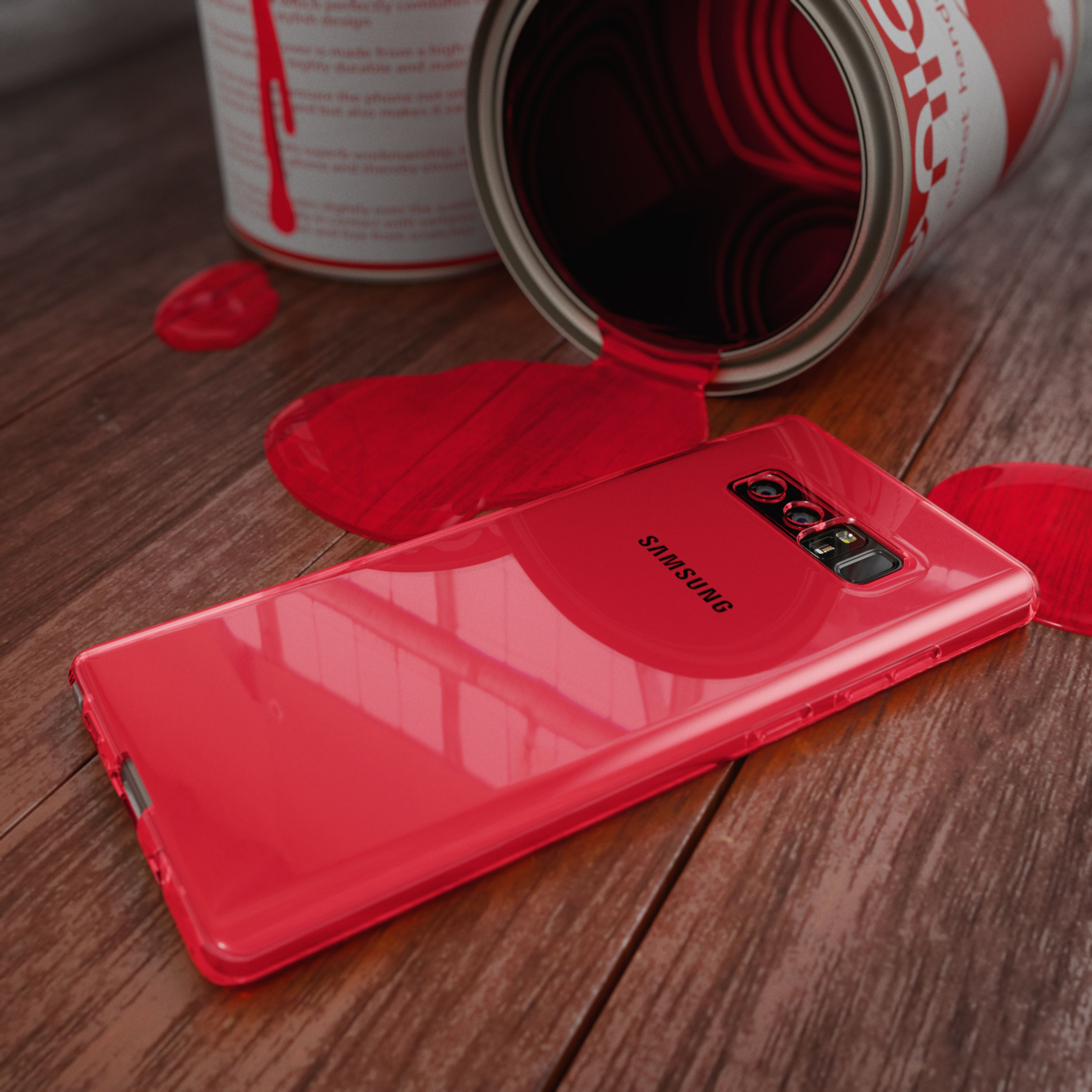 Ein rotes Smartphone liegt auf einem Holztisch neben einer umgekippten Farb dose mit roter Farbe.