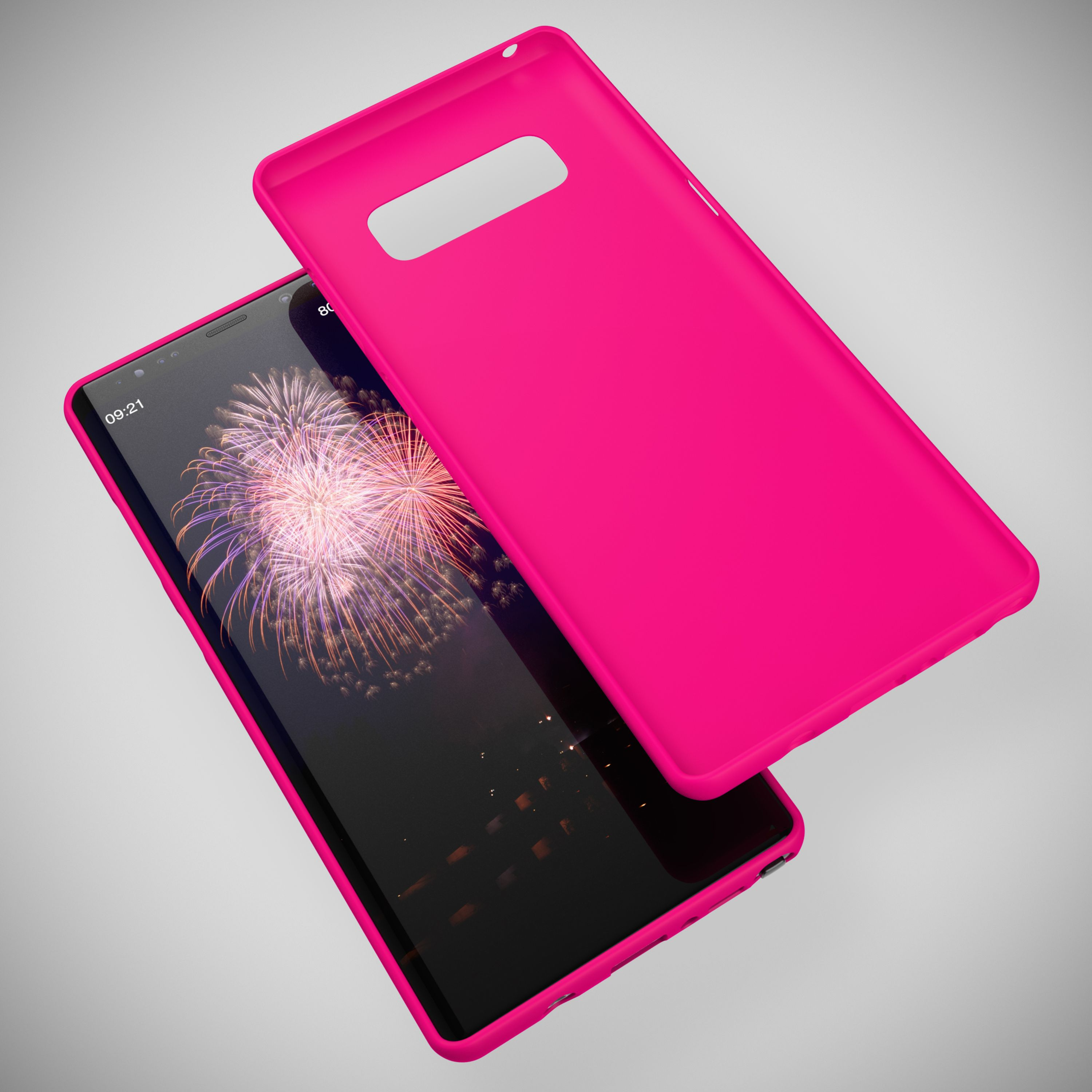 Ein pinkes Handycover liegt neben einem Smartphone mit Feuerwerk-Hintergrund.