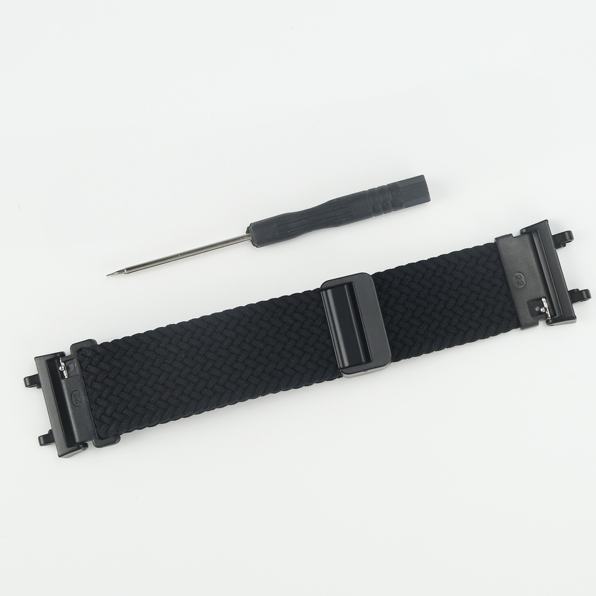 Schwarzes Uhrenarmband mit Schnalle und Schraubendreher auf weißem Hintergrund.