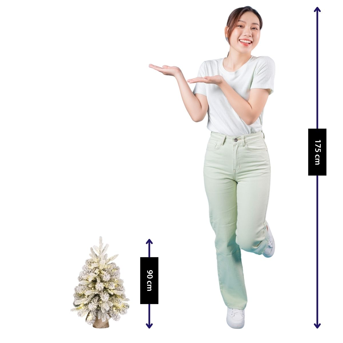 A woman (175cm) stands next to a lit Christmas tree (90cm).