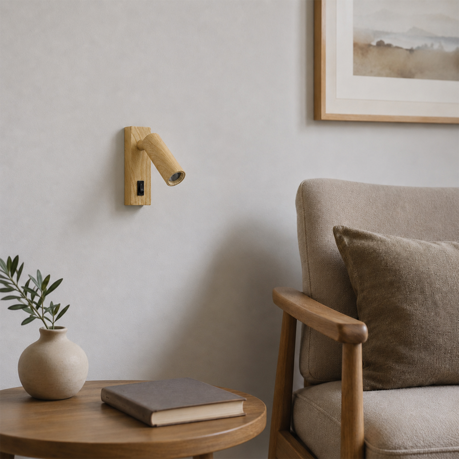 Mesita de noche con libro y jarrón junto a un sillón. Lámpara de pared de madera.