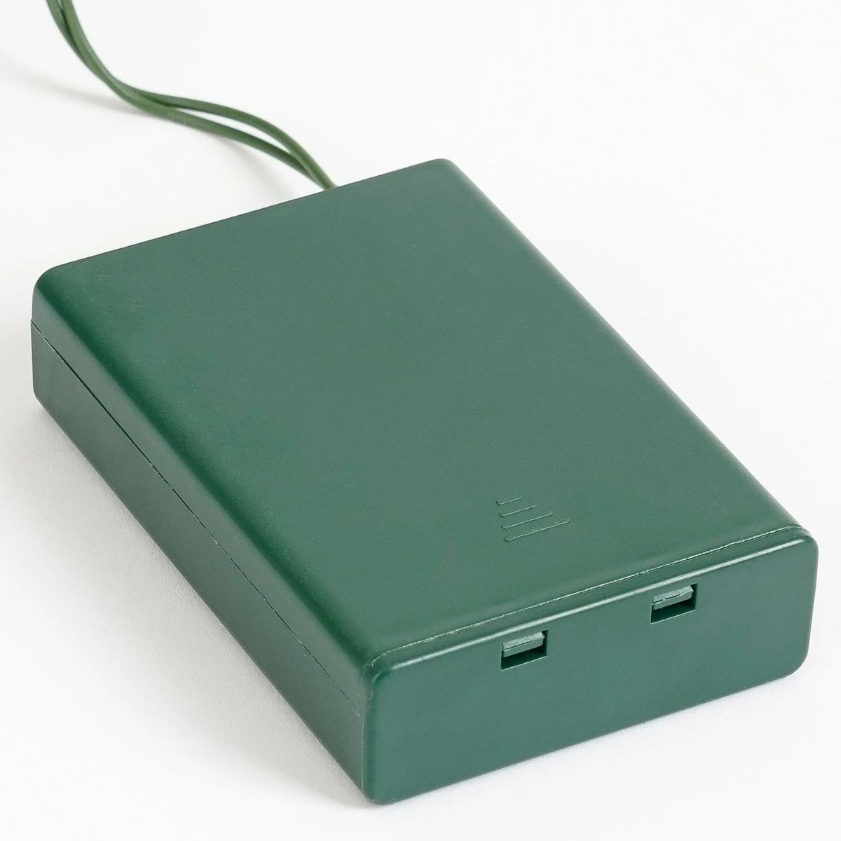 A dark green battery pack with two slots on the front and a green wire.