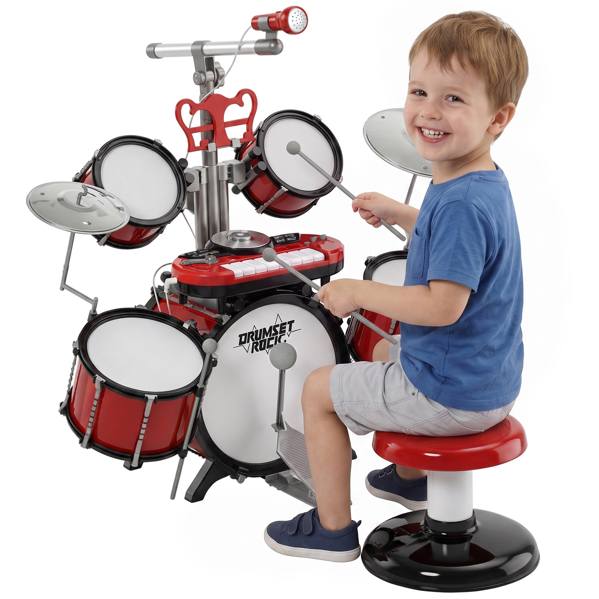 Un bambino sorridente in maglietta blu suona una batteria giocattolo rossa con tastiera e microfono.