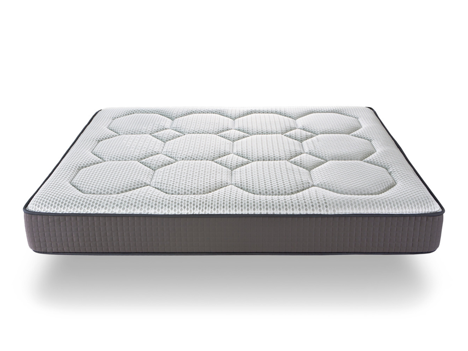 Un colchón con borde gris y parte superior blanca con patrón hexagonal.