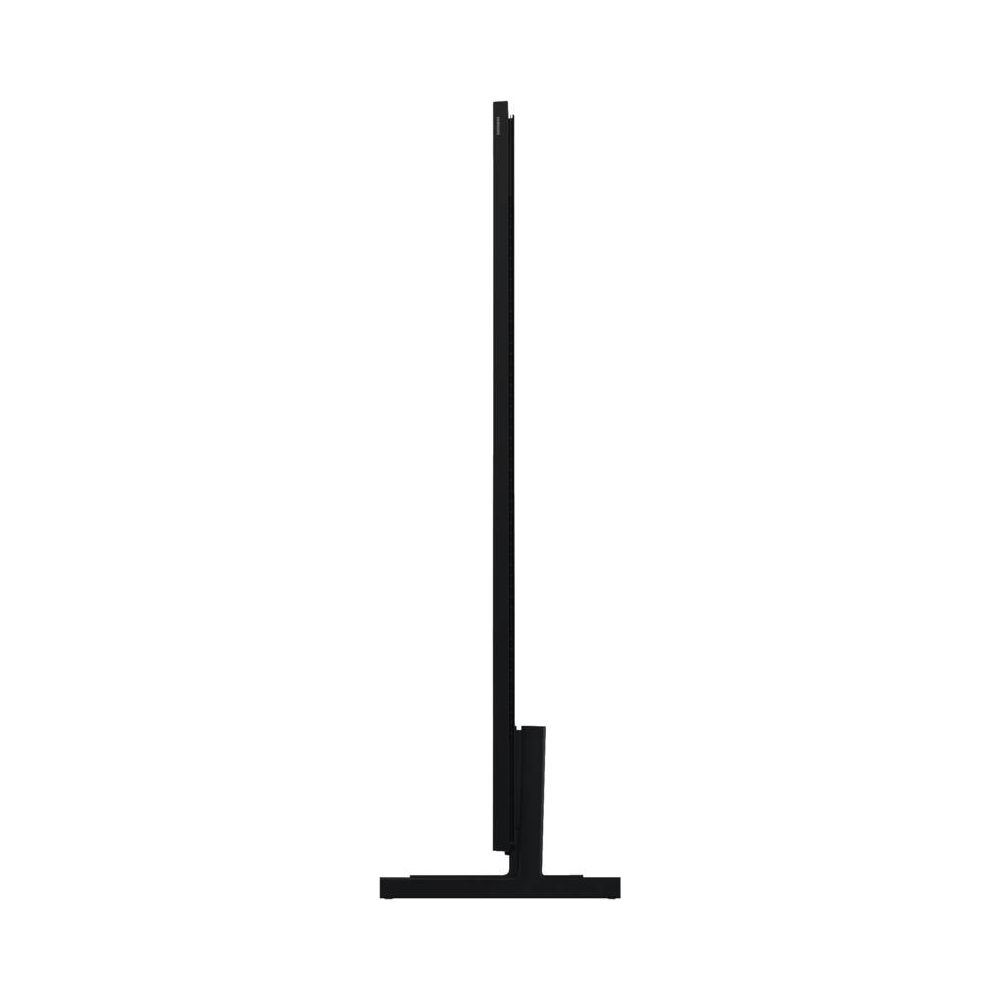 Un téléviseur noir avec un pied étroit, vu de côté.