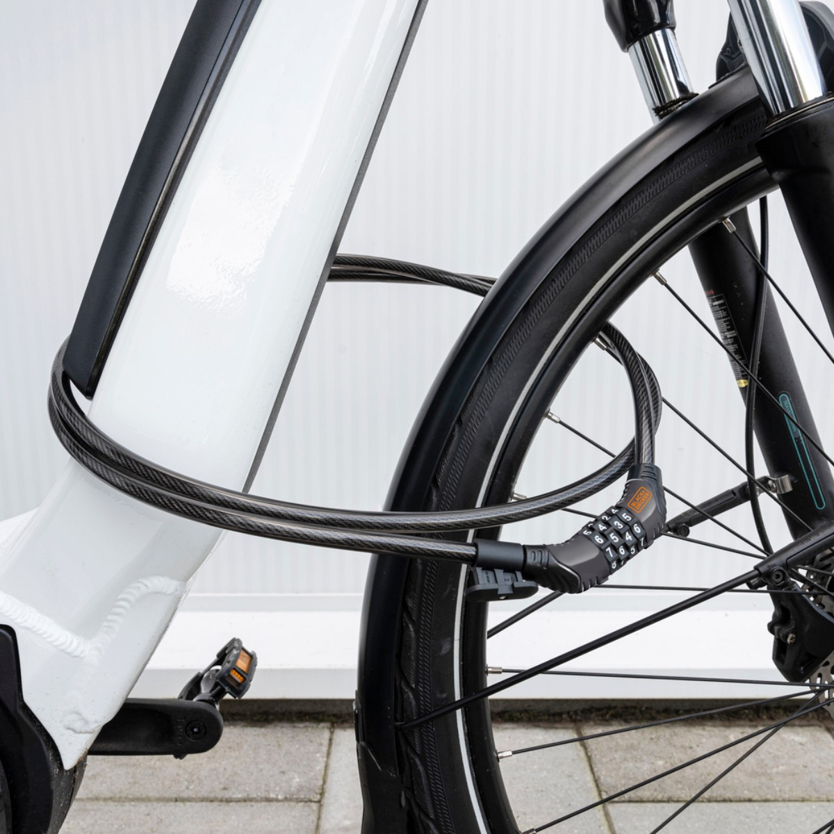 A white bicycle with a black cable lock wrapped around its frame and front wheel.