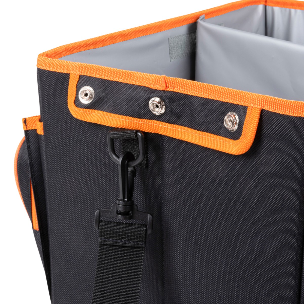 Black bag with orange trim and snaps. A black strap hangs from it.