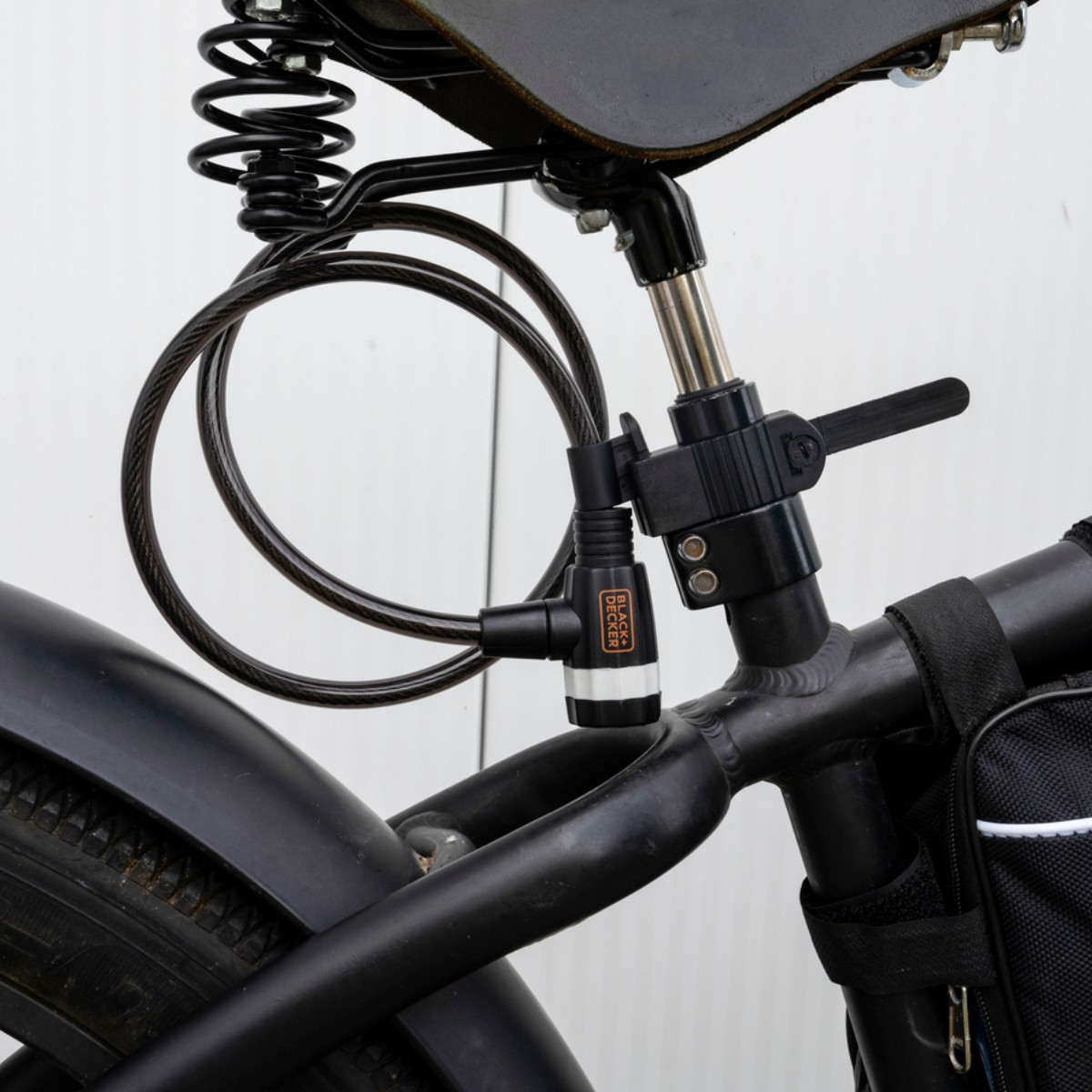 Close-up of a black cable bicycle lock attached to the seat post.