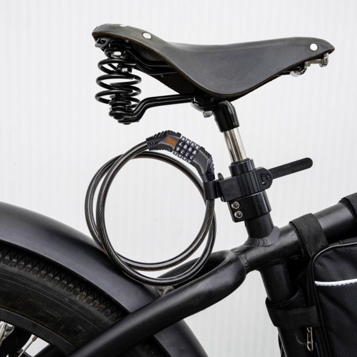 A black combination bike lock coiled around the seat post and frame.