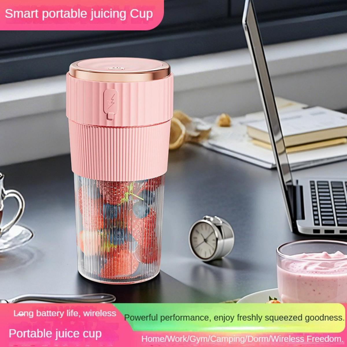 Ein pinker Mixer mit Beeren gefüllt steht neben einem Laptop und Smoothie.