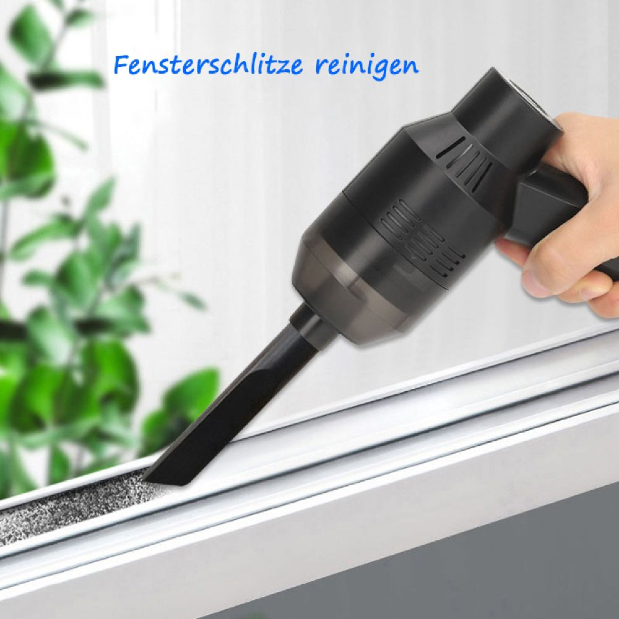 Ein schwarzer Handstaubsauger reinigt eine schmutzige Fensternut.