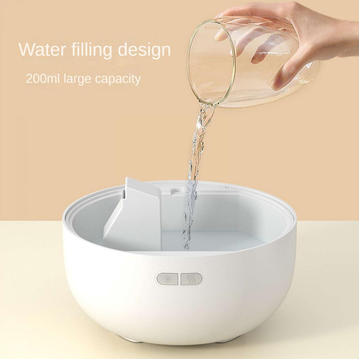 Wasser wird aus einem Glas in ein weißes Gerät gegossen.