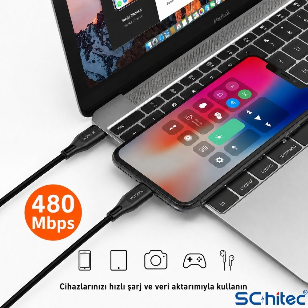 Bir iPhone X, siyah bir kablo ile MacBook'a bağlı.
