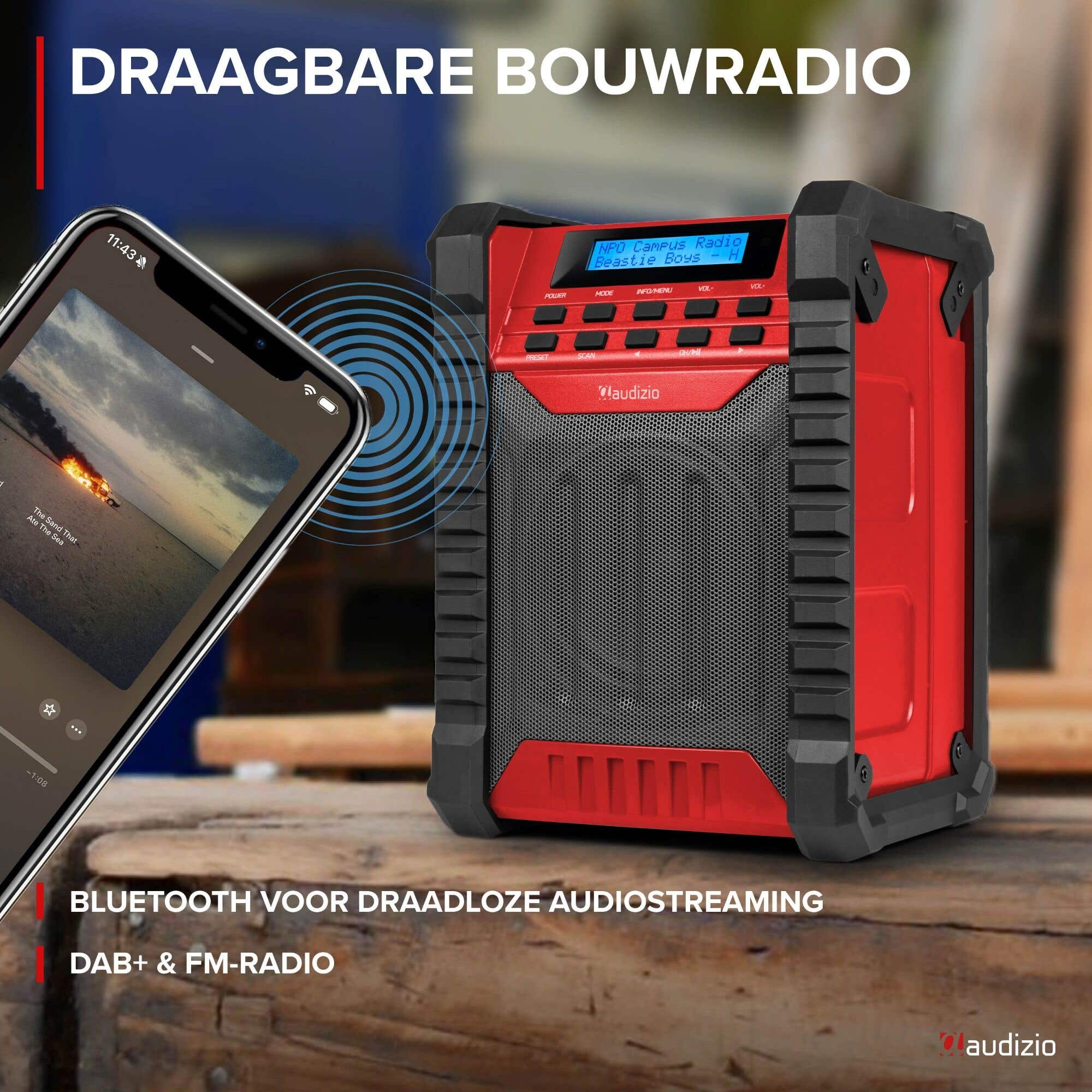 Ein rotes und schwarzes tragbares Radio mit einem Smartphone, das Musik abspielt.
