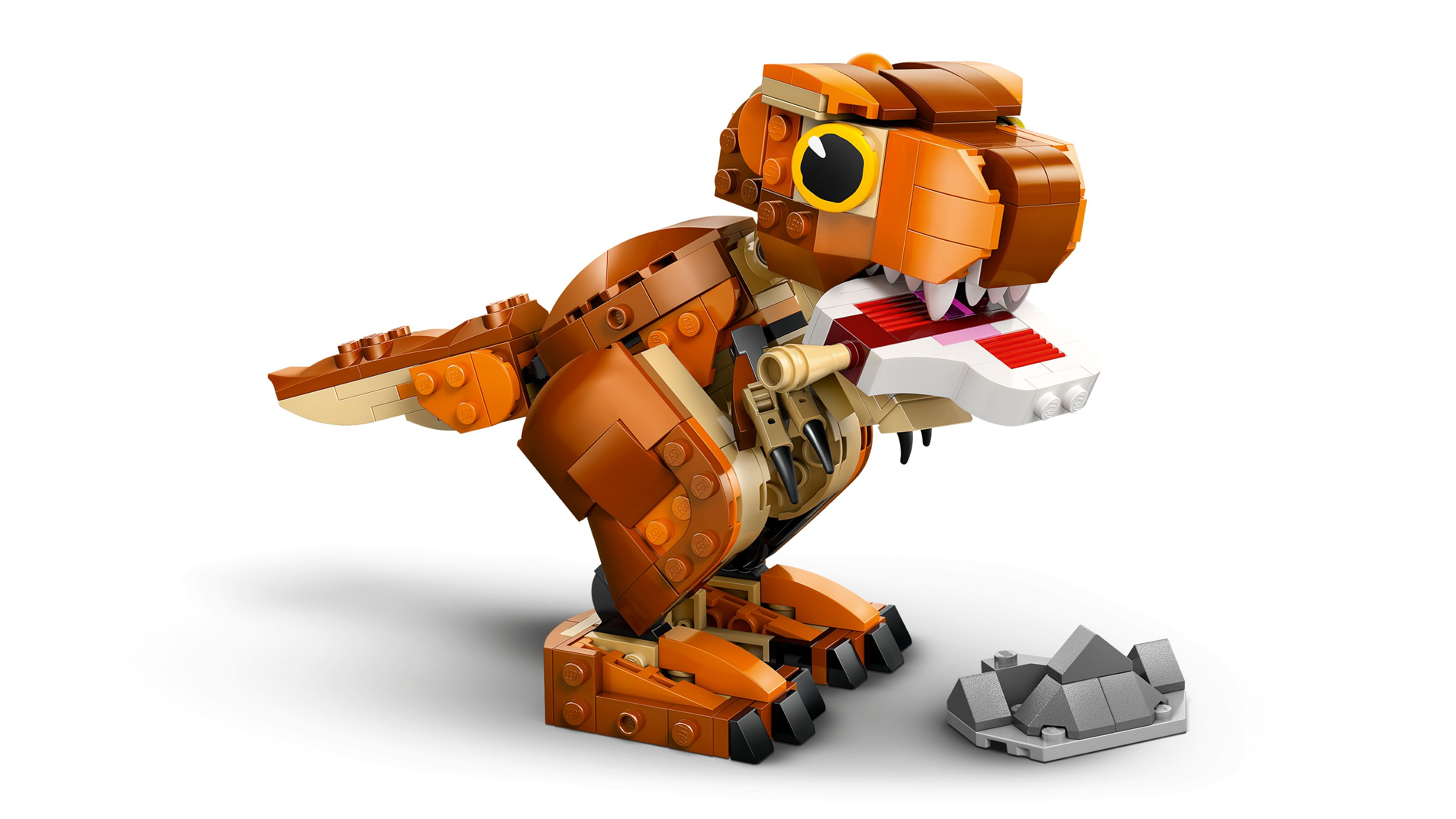 Orange Lego Tyrannosaurus Rex Spielzeug mit offenem Maul und grauem Felsaccessoire.