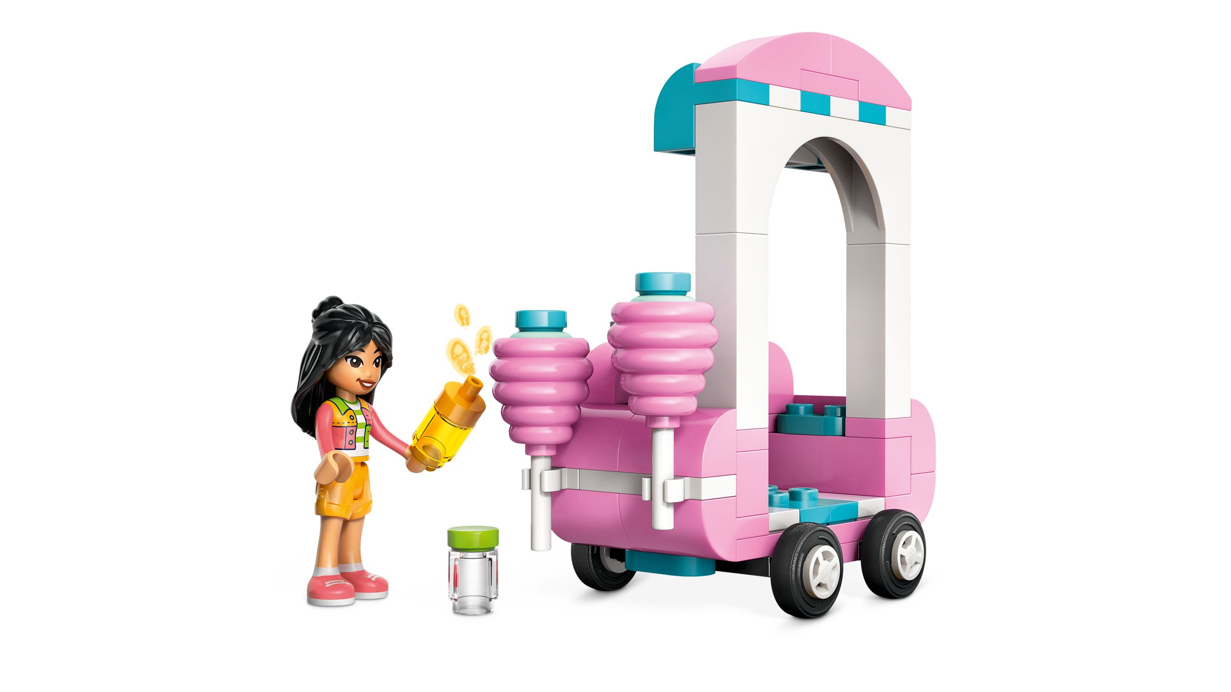 Eine Lego-Figur mit gelbem Becher vor einem pinken Verkaufsstand mit zwei rosa Säulen.