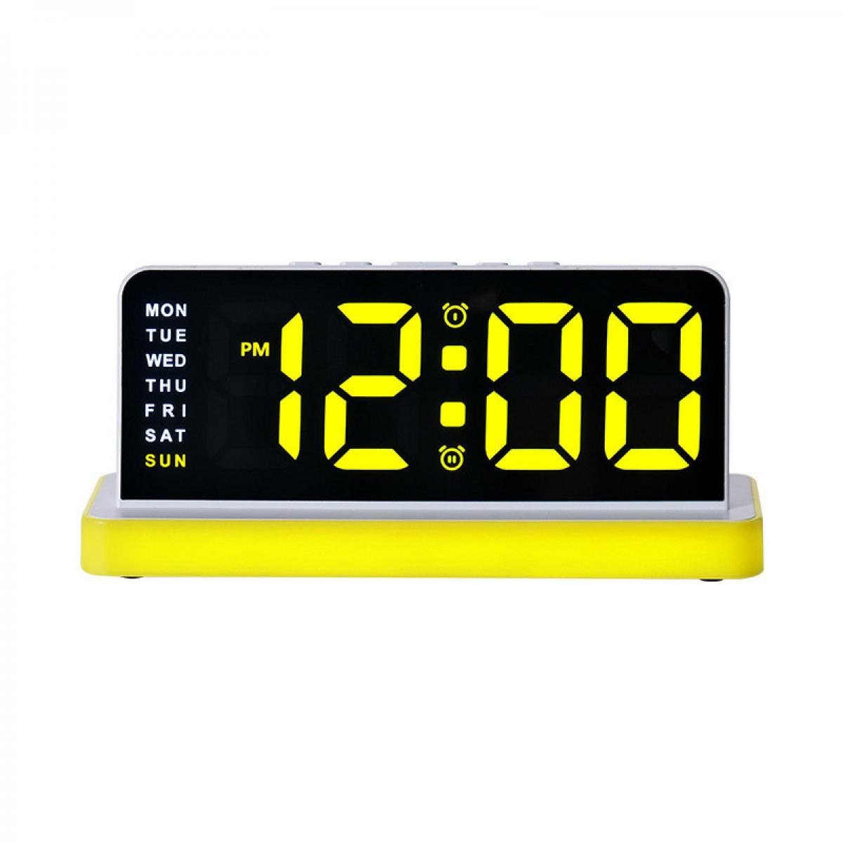 Digitaluhr zeigt 12:00 PM an, mit gelbem Gehäuse und Wochentagsanzeige.