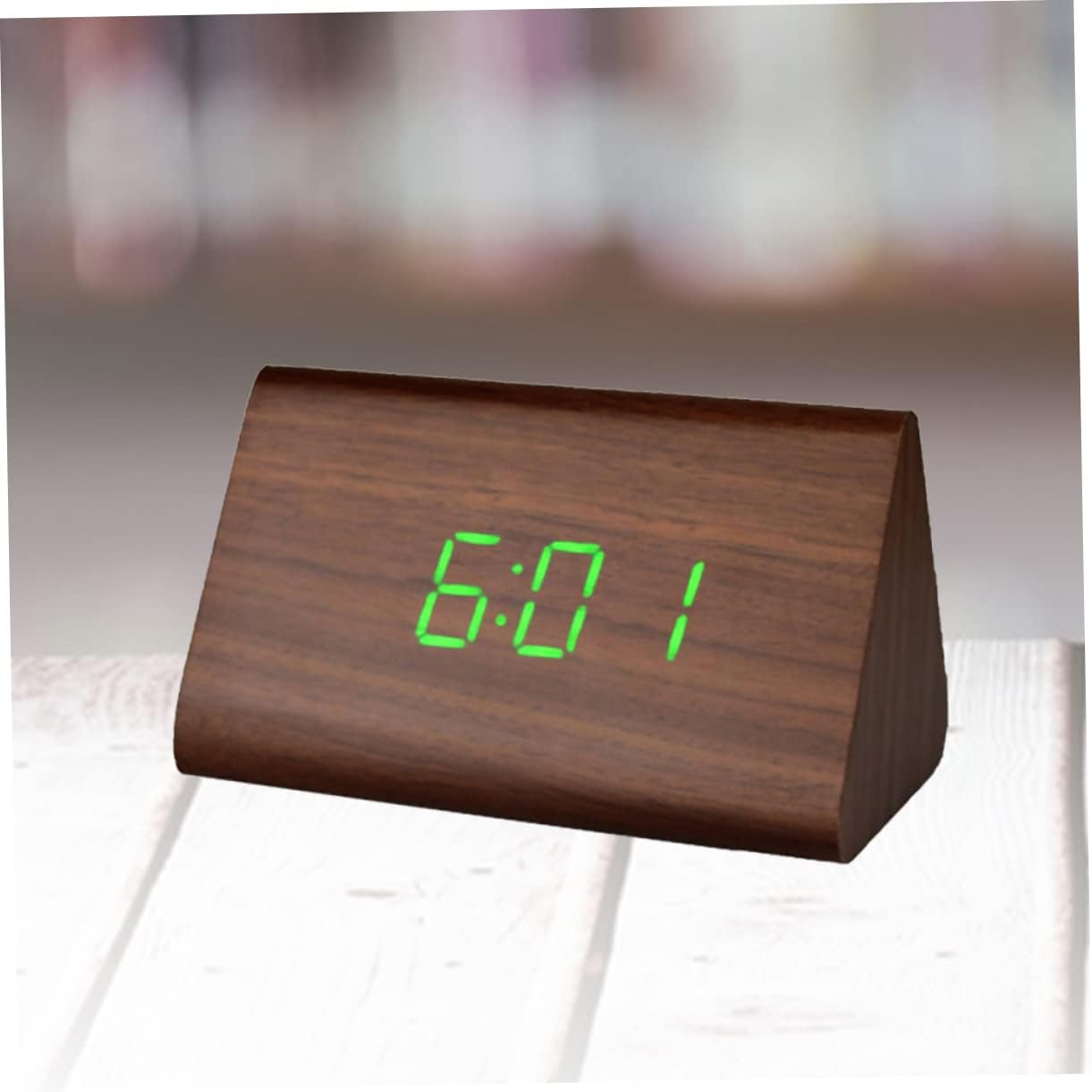 Ein hölzerner Digitalwecker zeigt grün 6:01 an.