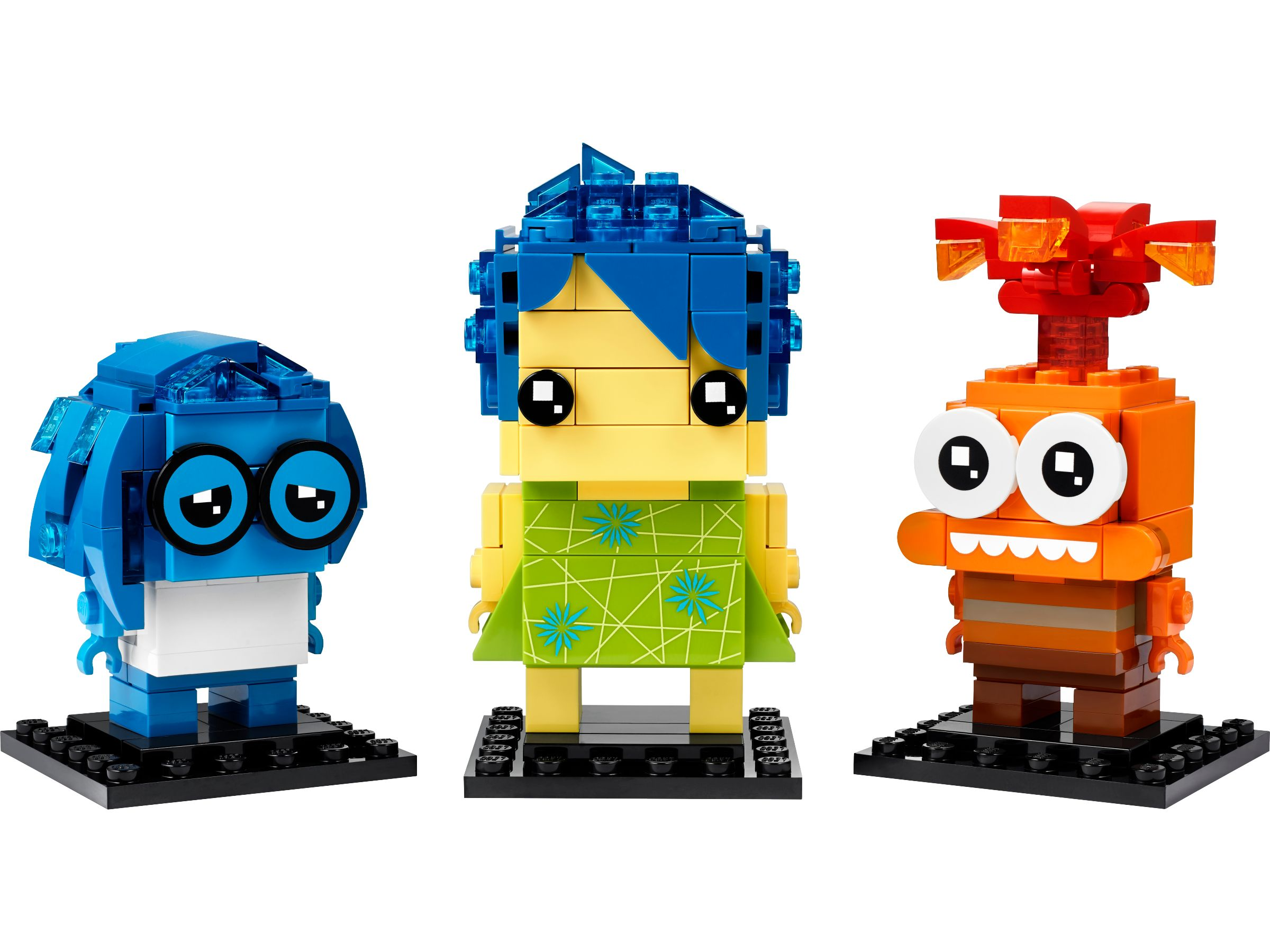 Drei Lego-Figuren: Freude, Traurigkeit und Wut auf schwarzen Sockeln.