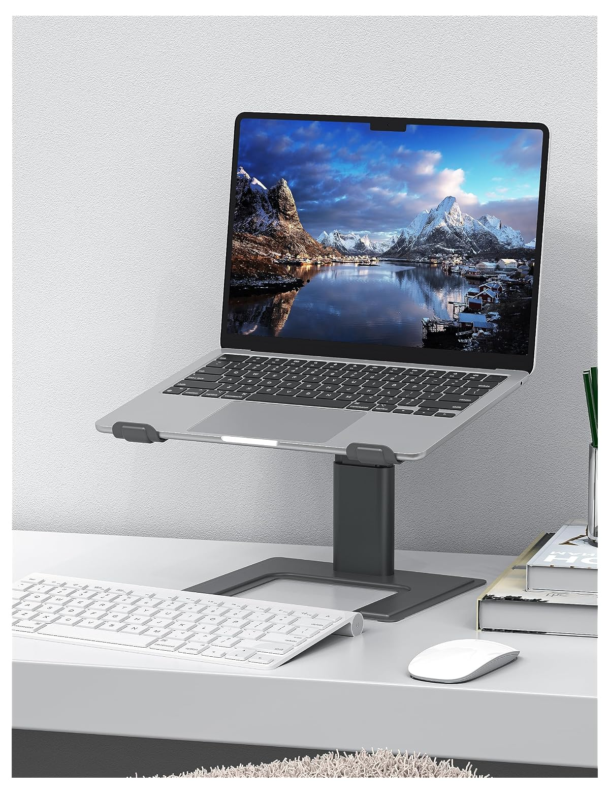 Ein Laptop auf einem Ständer über einer Tastatur und Maus.