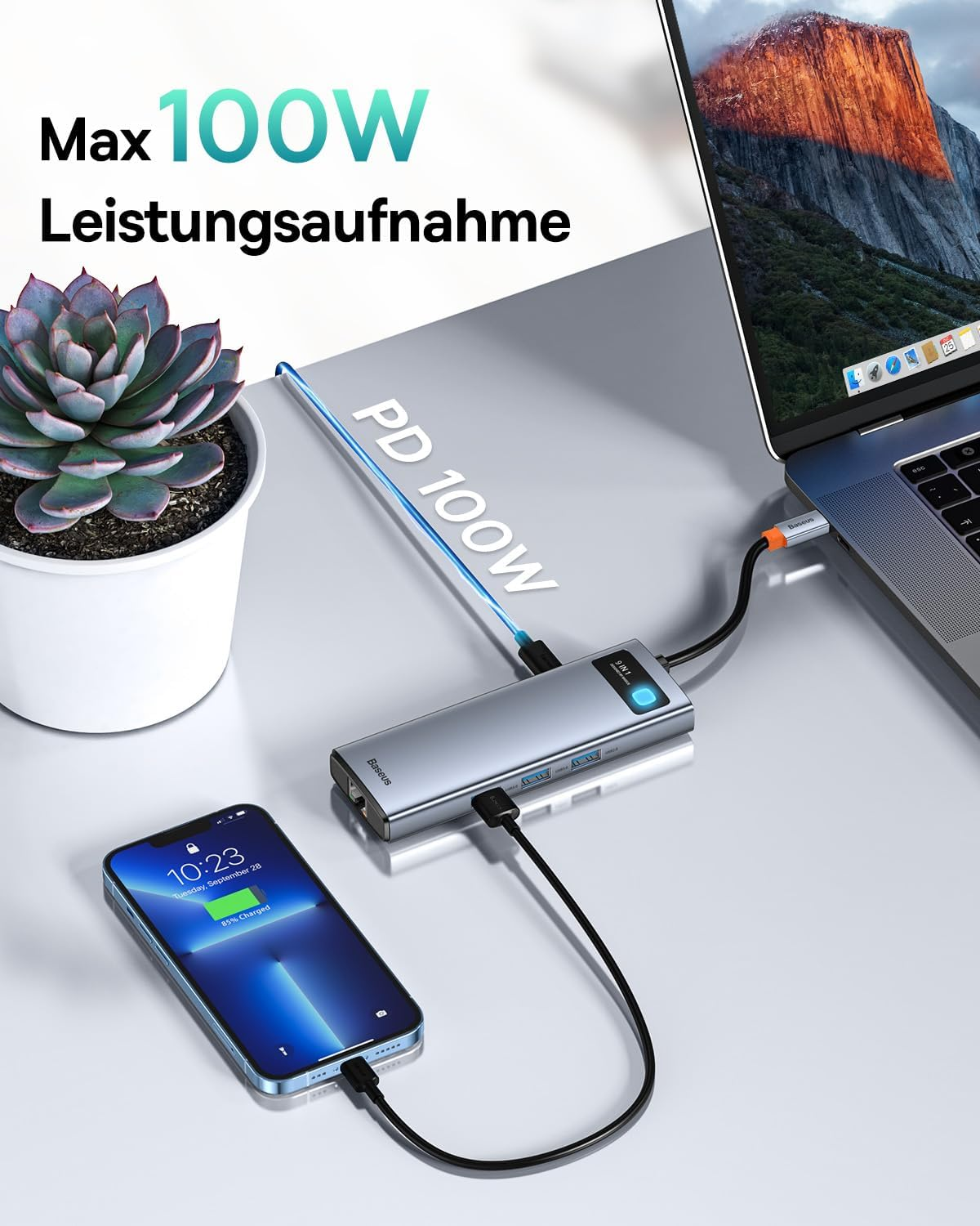 Ein Baseus 9-in-1 Hub lädt ein iPhone und einen Laptop, mit 100W Ladeleistung.