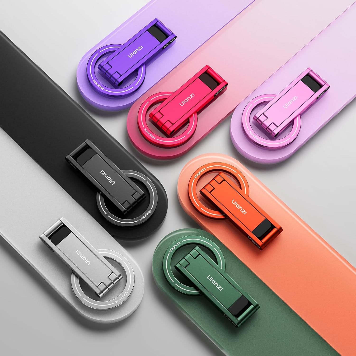 Múltiples soportes magnéticos para teléfono en varios colores sobre fondo de color.