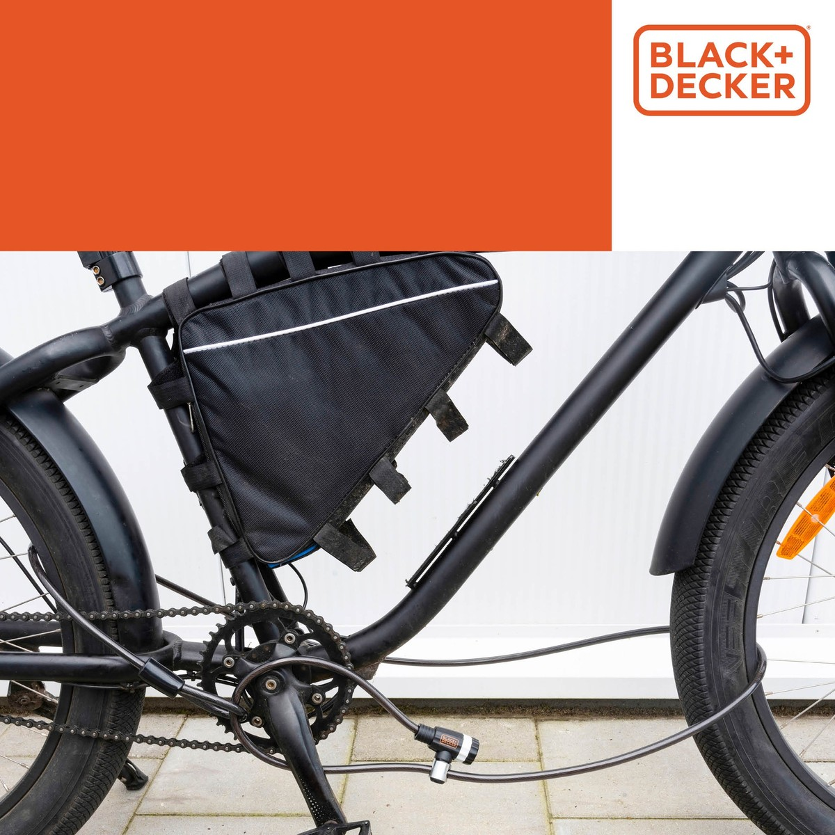 Black bicycle with a black frame bag and a cable lock around the crank.