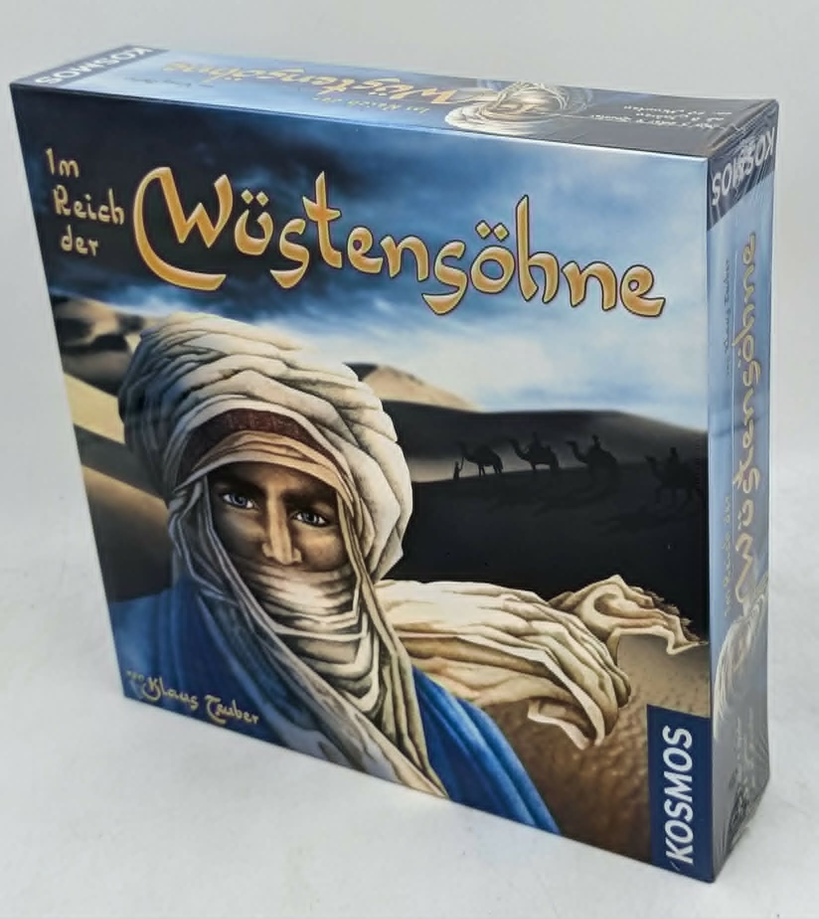 Brettspielkarton für Im Reich der Wüstensöhne mit einem Mann mit Turban und Kamelkarawane.