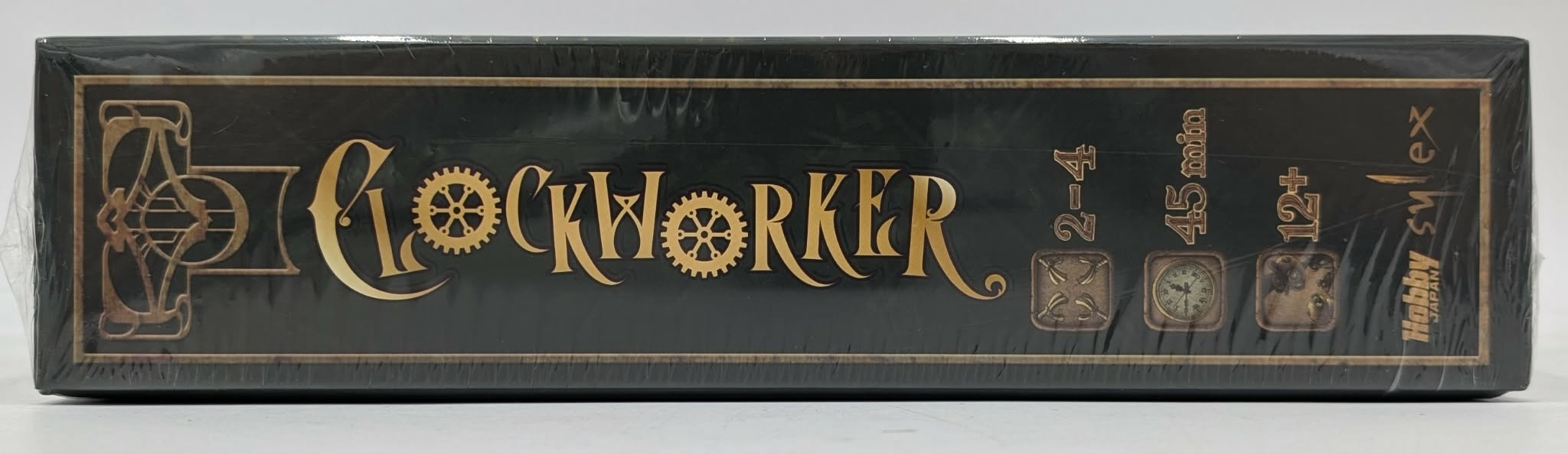 Die Seite einer Clockworker-Brettspielschachtel in Schwarz und Gold mit Spieleranzahl, Dauer und Altersangabe.