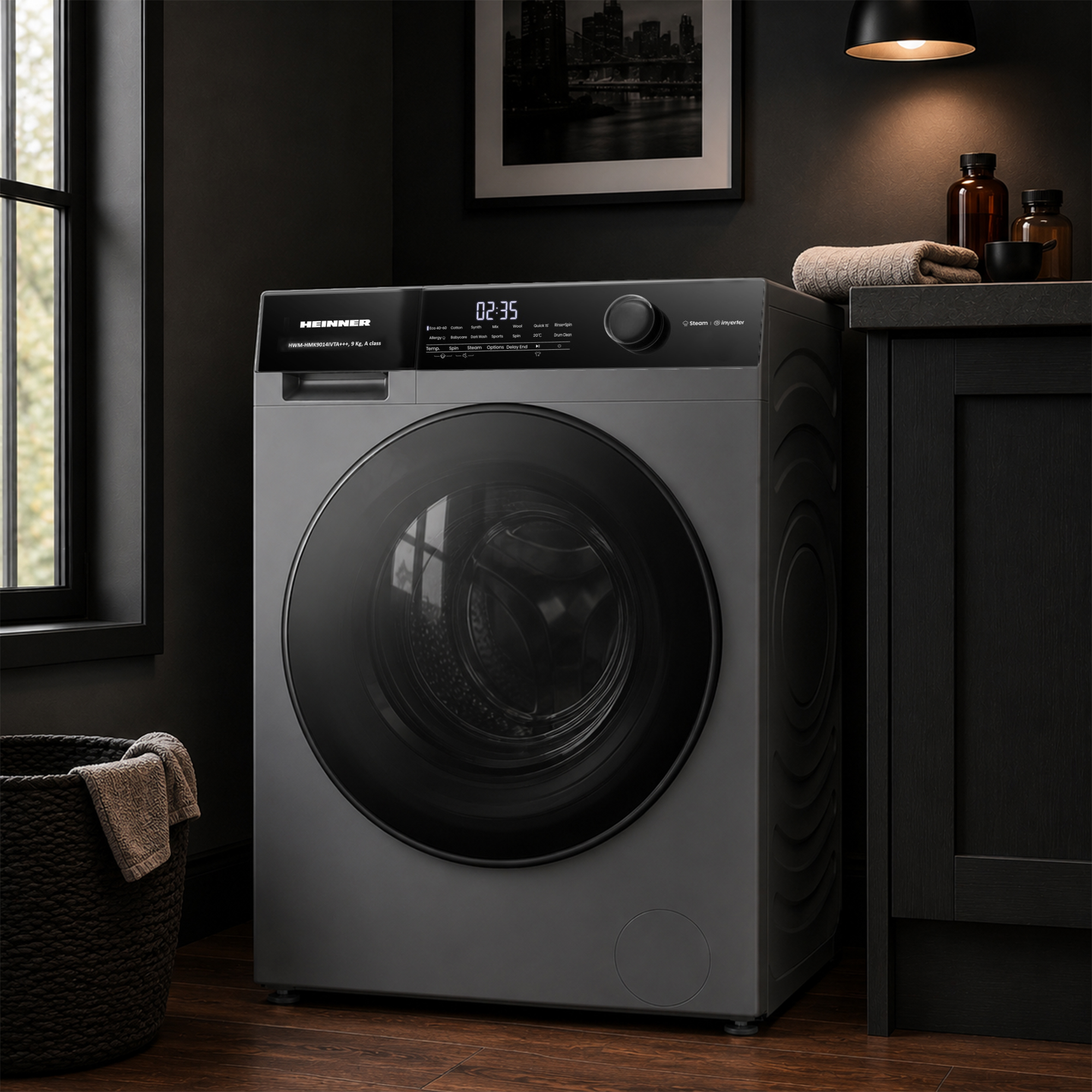Un lave-linge gris moderne à chargement frontal se trouve dans une buanderie sombre avec un panier en osier.