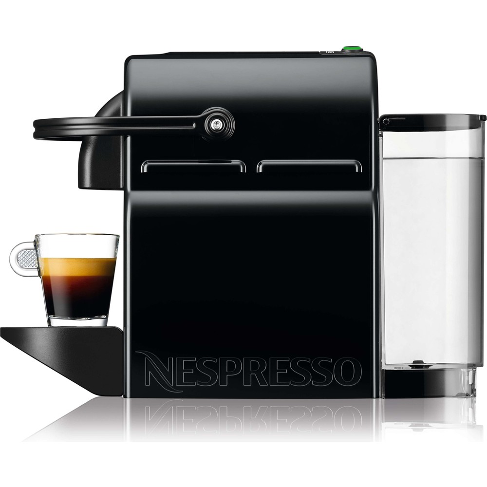 Tepsisinde cam espresso bardağı ve sağda su haznesi olan siyah bir Nespresso kahve makinesi.