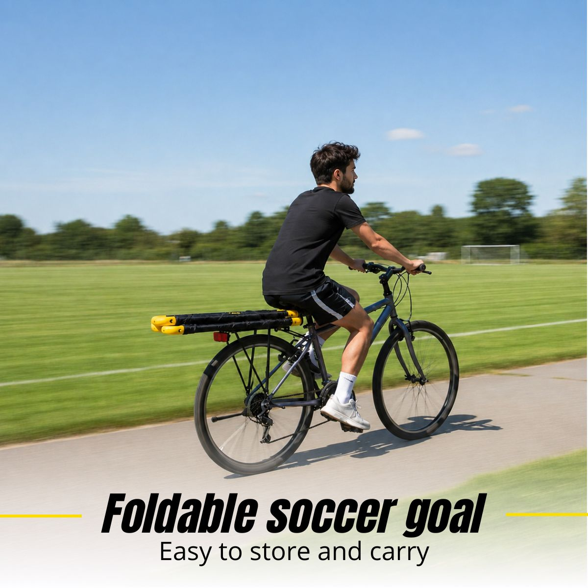 A man rides a bicycle on a paved path, carrying a folded yellow and black soccer goal on the back.